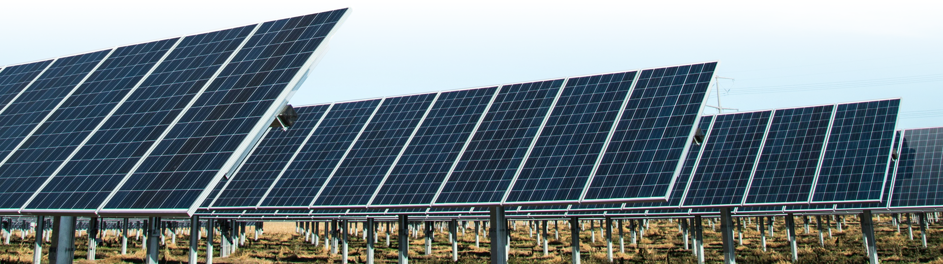 A large solar panel sitting in the middle of an open field.